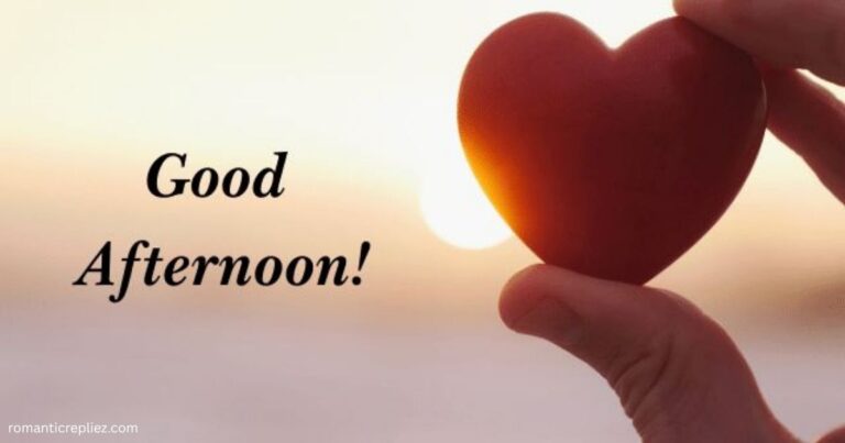 Hand holding a red heart at sunset with “Good Afternoon!” text.